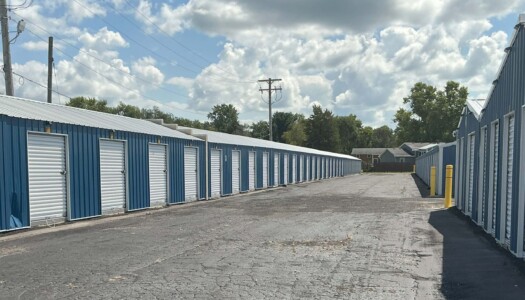 Row of drive up blue metal storage units with white doors