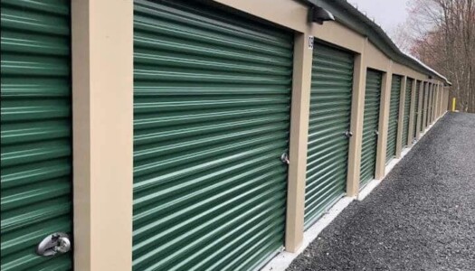 Drive Up Storage Units w Green Roll Up Doors