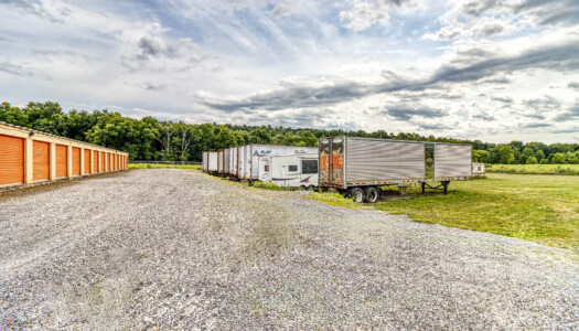 Drive-up storage units and row of vehicles being stored