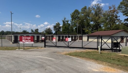 Black iron gate to drive-up self-storage facility
