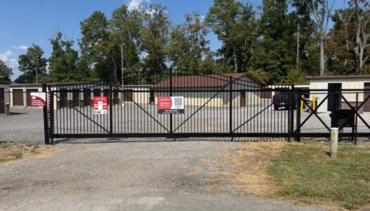 Black iron gate to drive-up self-storage facility