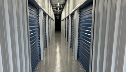 Hallway of indoor climate-controlled storage units with blue doors