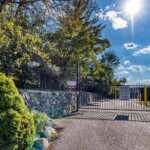 The sun shining brightly down on the keypad and facility entrance gate