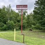 Large Storage Sense sign and the storage facility entrance keypad