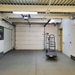Loading bay with a garage door and moving dollies