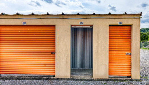 One medium storage unit next to two small with one small that has its door open