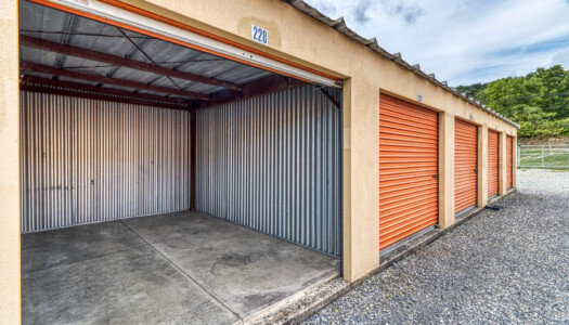 Row of 3 storage units with one large storage unit open
