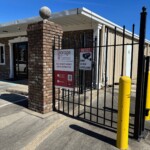 Entry gate to Storage Sense in Oxford, AL with security measures like cameras
