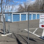 Entry gate with drive-up storage units behind a secure fence