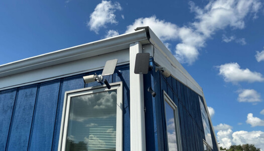 Security cameras on blue metal storage unit building