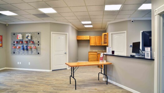 office with an on-site management desk for in-person customer service and moving supplies for sale on the wall