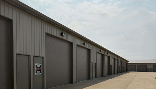 Gray metal drive-up storage facility with brown doors